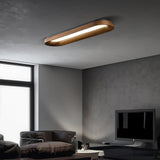 Linear ceiling light lit above a sofa in a gray room with a wall mounted screen