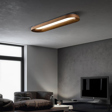 Linear ceiling light lit above a sofa in a gray room with a wall mounted screen