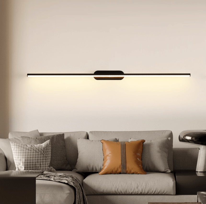 Thin rod lit above a pale sofa with cushions in a warm toned living room