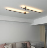 Lit above a pale sofa in a living room, the rods crossing the wall in a line