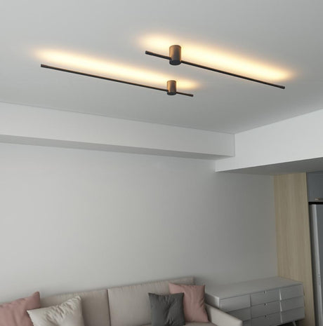 Lit above a pale sofa in a living room, the rods crossing the wall in a line