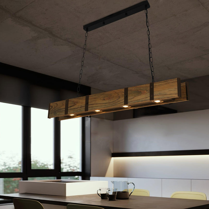 Hung above a kitchen island and stools in a room with a wide window