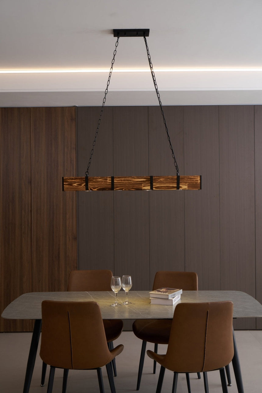 The beam seen across a room under a ceiling cove with a dining set below