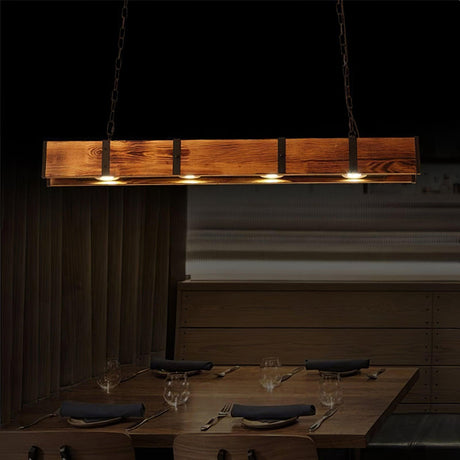 The beam lit over a set table with glasses and napkins in a dark room