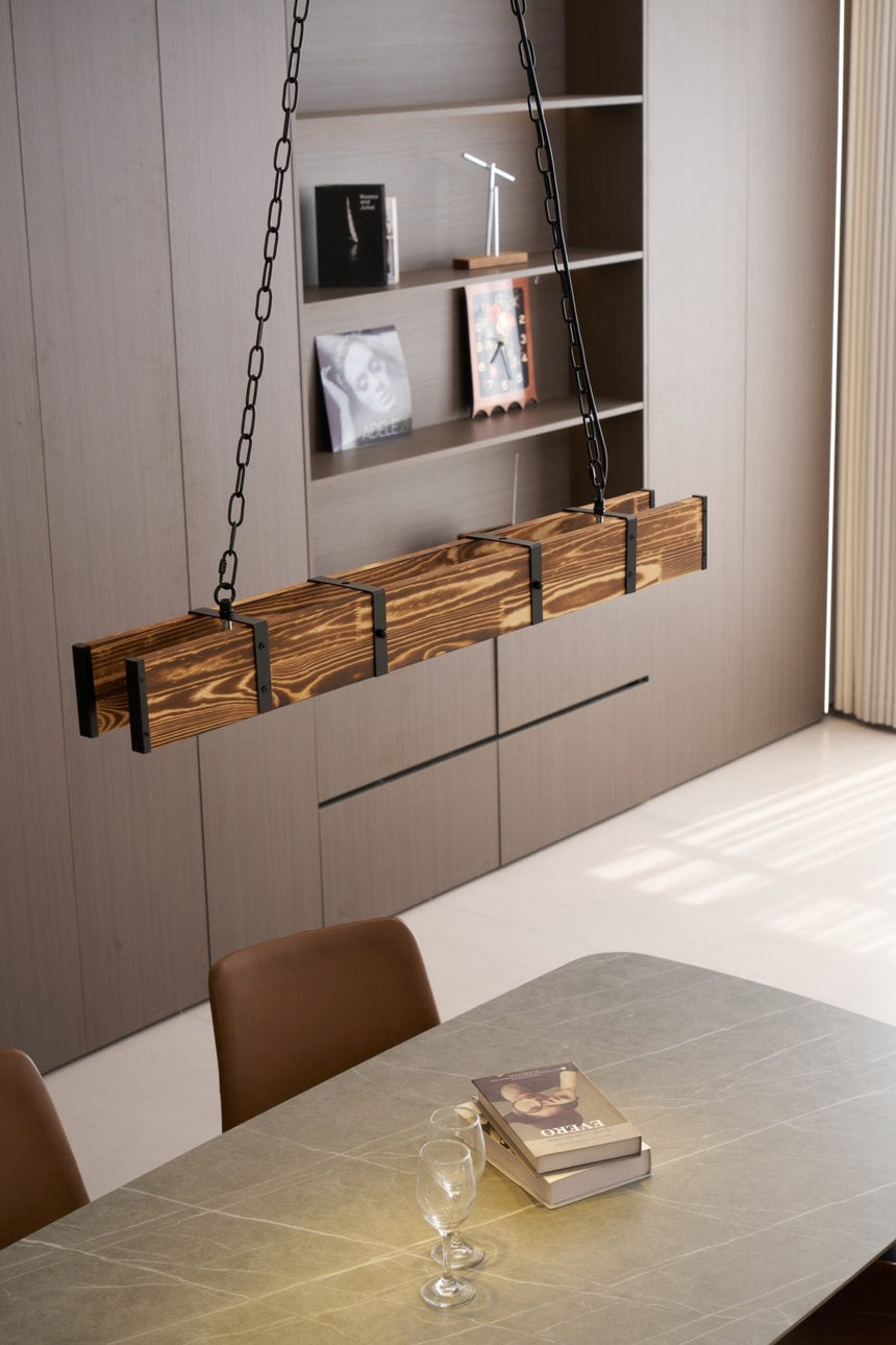 Lit over a long table beside wall shelving with a bright window at the end