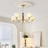The bells lit above a console table in a room with a tall window