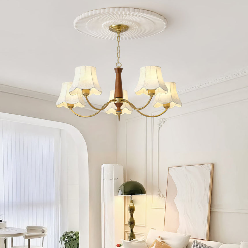The bells lit above a console table in a room with a tall window
