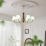 The fitting lit by a window blind above a chair and a side table