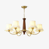 Linen chandelier with white fabric bells on a turned walnut column