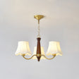The three light build, brass arms and three fabric bell shades