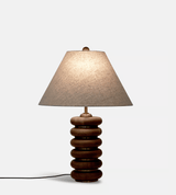 Close view of the lit linen empire shade above the wood rings