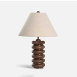 Linen shade table lamp unlit and seen at a slight angle