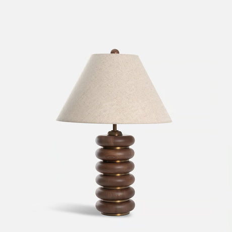 Linen shade table lamp unlit on a plain pale ground, front view