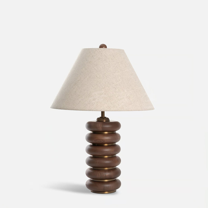 Linen shade table lamp unlit on a plain pale ground, front view