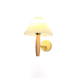 The sconce unlit on a pale wall showing the shade, arm and plate together