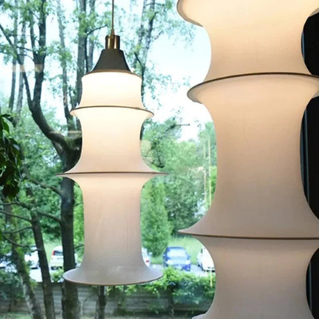 Stacked silk column seen against a window with trees beyond