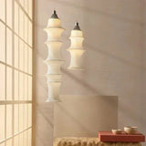 Two stacked silk columns hung at different lengths beside a staircase
