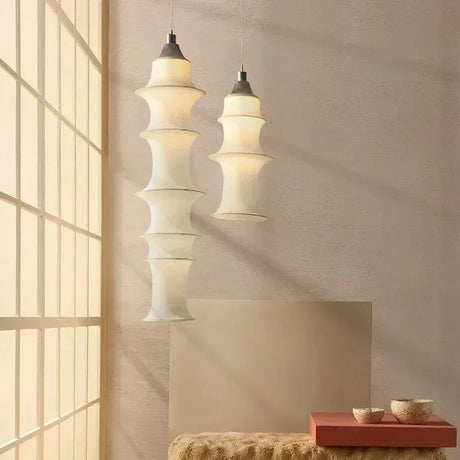 Two stacked silk columns hung at different lengths beside a staircase