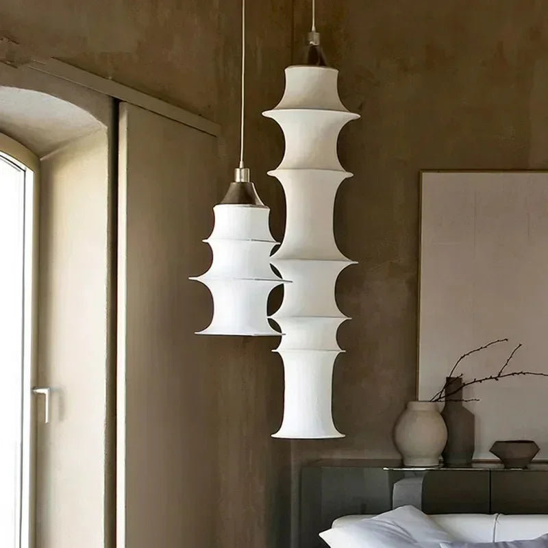 Living room hanging light in stacked silk segments, two lengths hung side by side