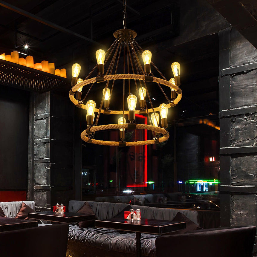 Two of the fittings lit in a dark lounge above low sofas and tables
