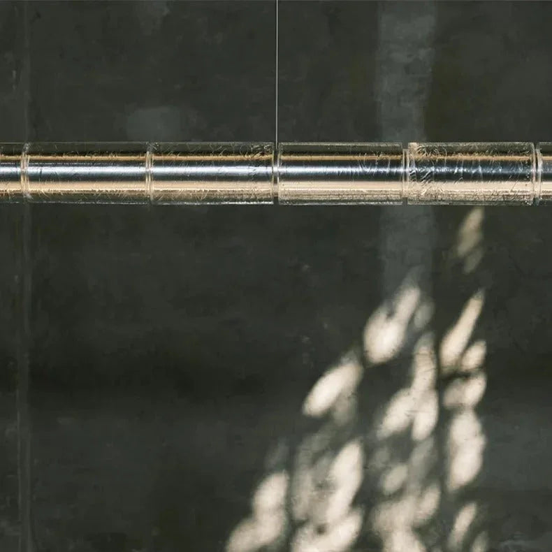Close view of the ribbed glass sleeve and the lit tube inside it