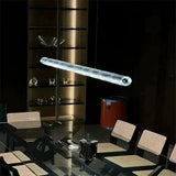 The ribbed glass bar lit above a restaurant table with glassware