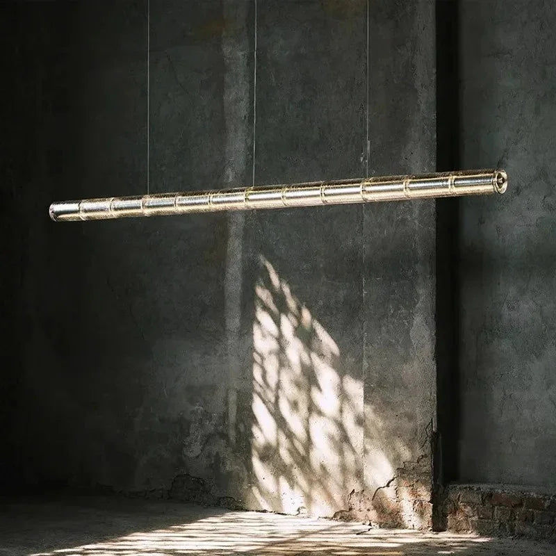 The ribbed glass bar lit against a dark stone wall in a bare room