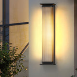Two lit in a recessed entry with a lit doorway between them at dusk