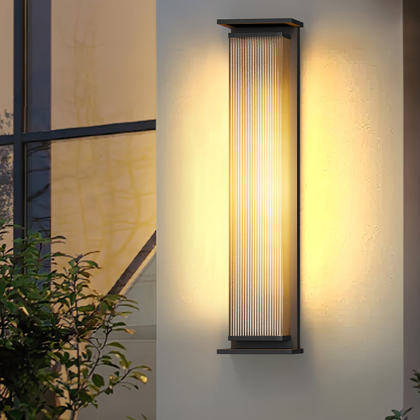 Two lit in a recessed entry with a lit doorway between them at dusk