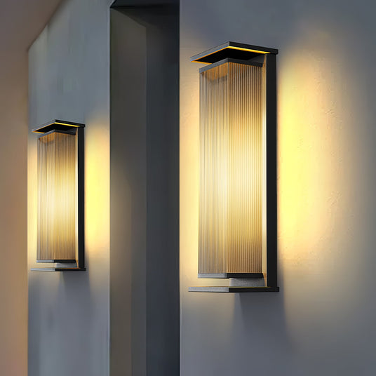 Two lit on render piers either side of a recess with a gravel bed