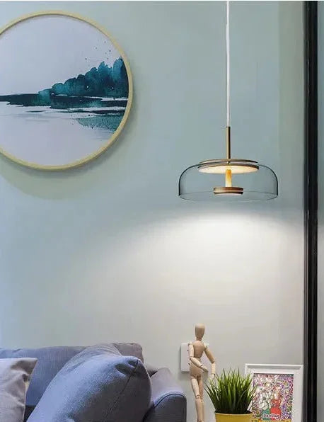 The glass dome lit beside a round mirror above a shelf with small objects