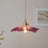The purple lotus shade seen alone against a plain pale background