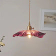 The purple lotus shade seen alone against a plain pale background