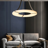 The lit ring in a living room with a sofa, cushions and a slatted dark wall