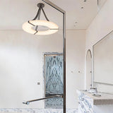 The lit ring in a white bathroom with a mirror, a basin and a shower