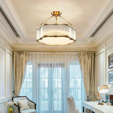 Lit drum in a paneled room with a bay window and patterned curtains