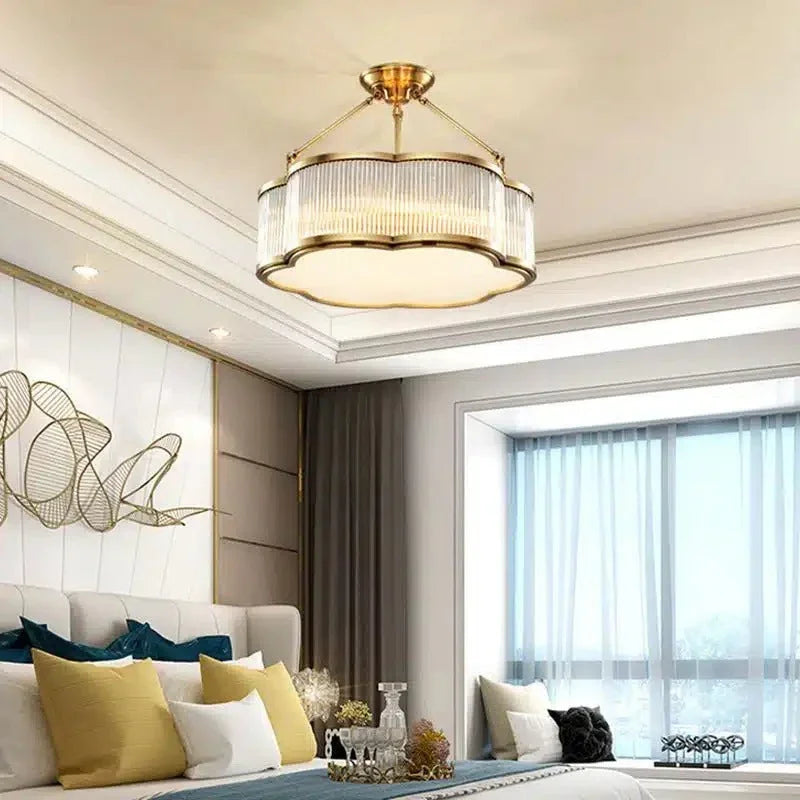 Lit drum in a bedroom with a yellow cushion on the bed and a bright window