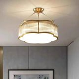Brass drum with fluted glass panels mounted close to a white ceiling