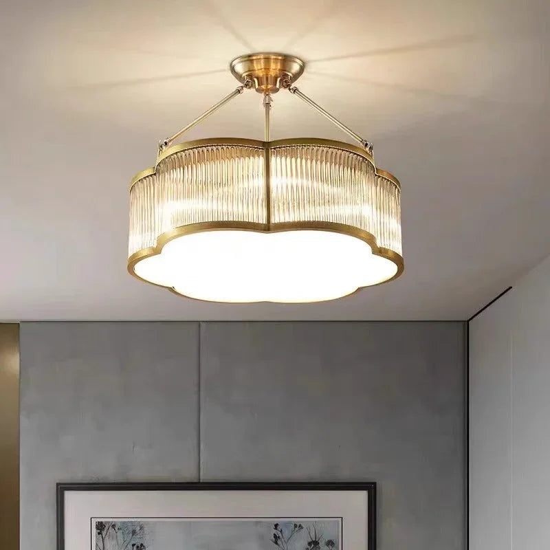 Brass drum with fluted glass panels mounted close to a white ceiling