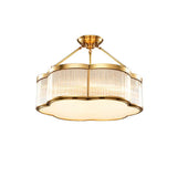 The brass and fluted glass drum seen on a plain white background
