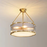 The drum throwing a warm ring of light onto a living room ceiling and walls