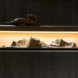 Close view of the carved peaks lit from behind inside the recess