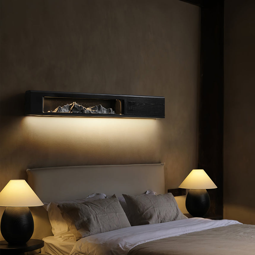 Black panel lit above a bed headboard between two table lamps