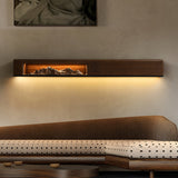 Walnut panel lit above a long low daybed in a plain room
