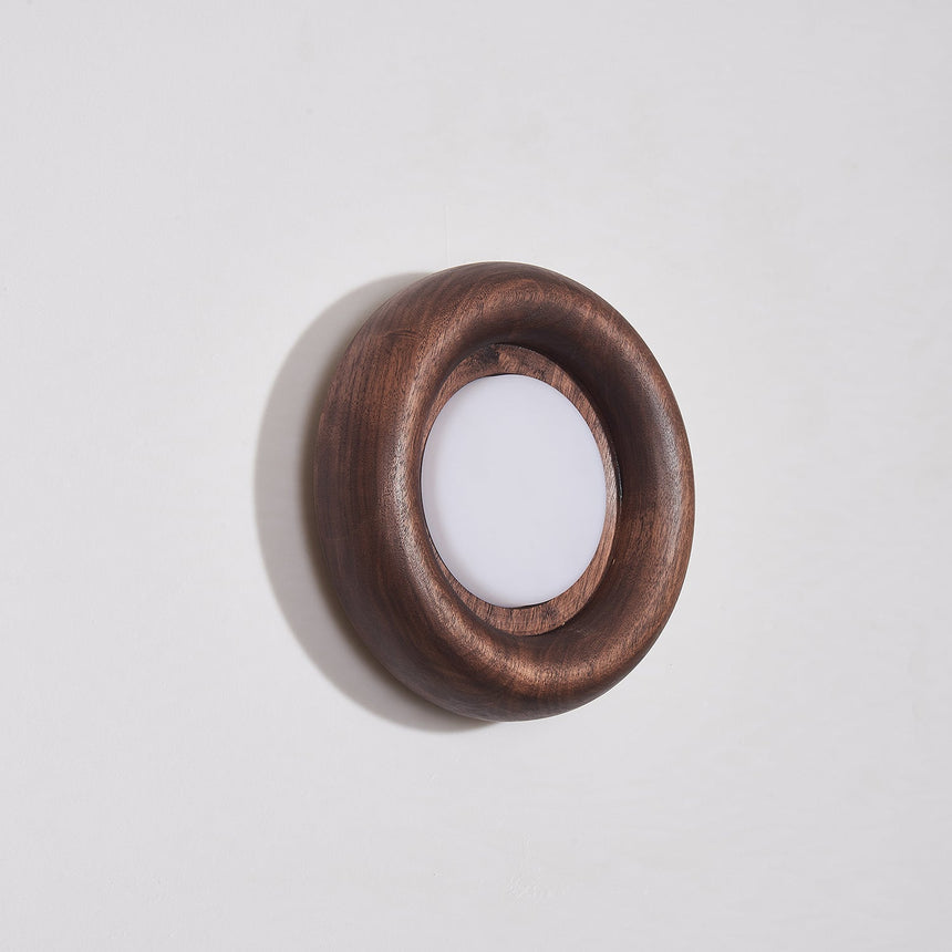 The walnut ring seen at an angle showing how little it stands off the wall