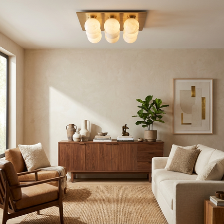 Nine ball alabaster ceiling light lit in a living room with a woven rug and a plant