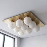 Brushed brass version of the nine ball alabaster ceiling light seen from below