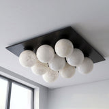 Matte black version of the nine ball alabaster ceiling light seen from below