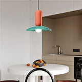 Metal pendant light illuminated above dining table