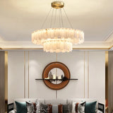 Marble ring chandelier in a living room beside a round mirror
